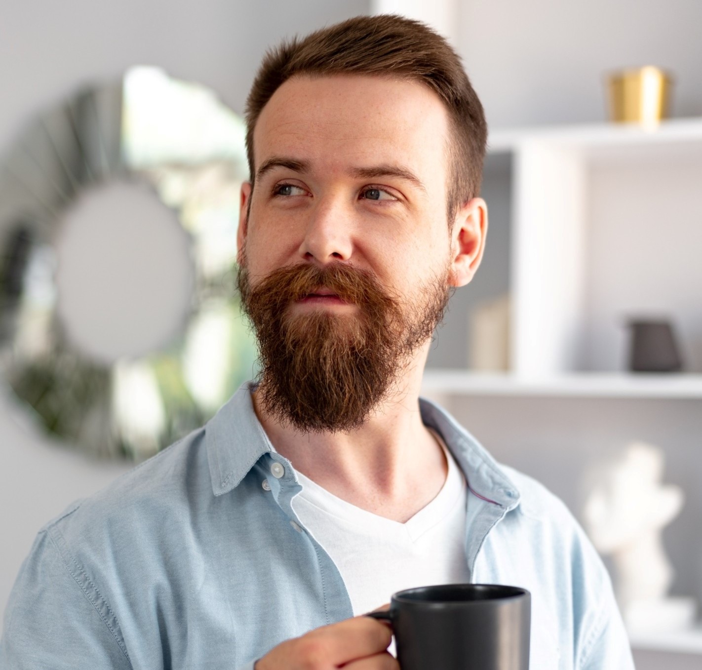 young bearded man smiling and drinking coff 1.jpg
